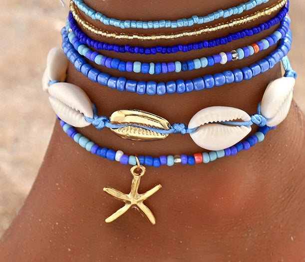 Blauwe enkelbandjes set met schelpen en gouden zeester bedel