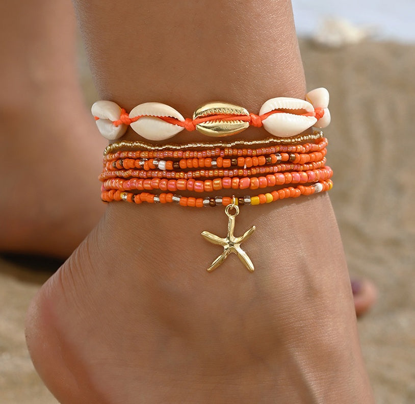 Oranje enkelbandjes set met schelpen en gouden zeester bedel