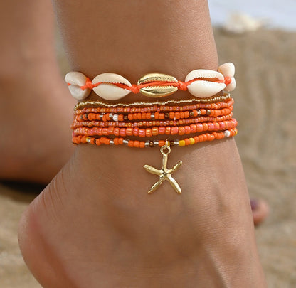 Oranje enkelbandjes set met schelpen en gouden zeester bedel