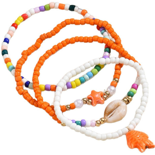 Enkelbandjes set oranje wit met schelp en zeester bedels