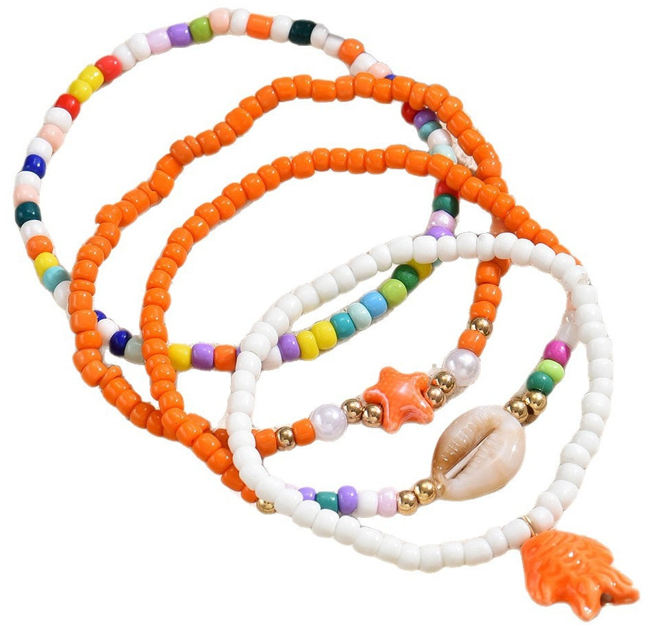Enkelbandjes set oranje wit met schelp en zeester bedels