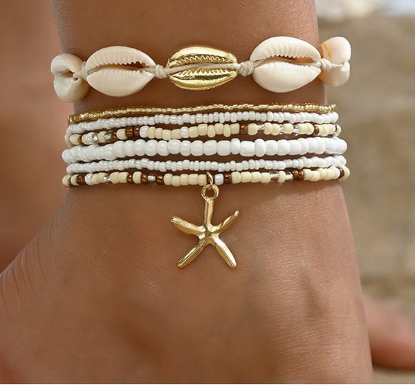 Witte enkelbandjes set met schelpen en gouden zeester bedel