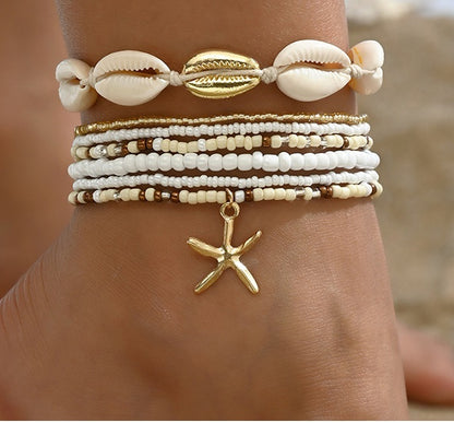 Witte enkelbandjes set met schelpen en gouden zeester bedel