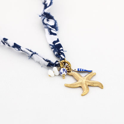Stoffen ketting blauw wit met goudkleurige zeester bedel - Medase